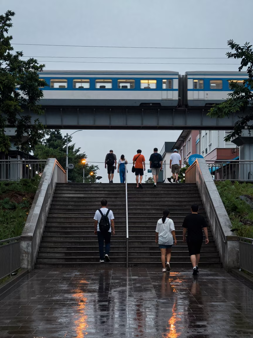 Twilight Commuters Ascend Wet Stairs in Kanasin in under an elevated train line in Kanasín