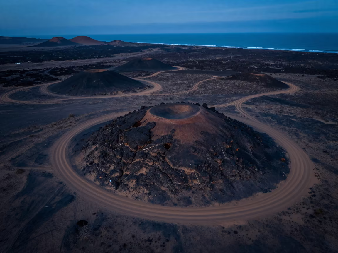 Twilight Desert Tracks Around Volcanic Cones in far above surf-scalloped coastline near Kathmandu