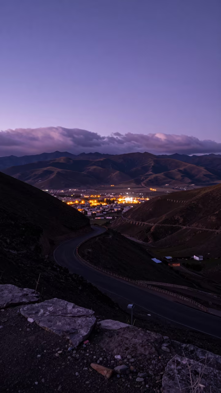 Twilight Mountain Road Over Lhasa Foothills in from a ridge above layered foothills near Sera, Lhasa