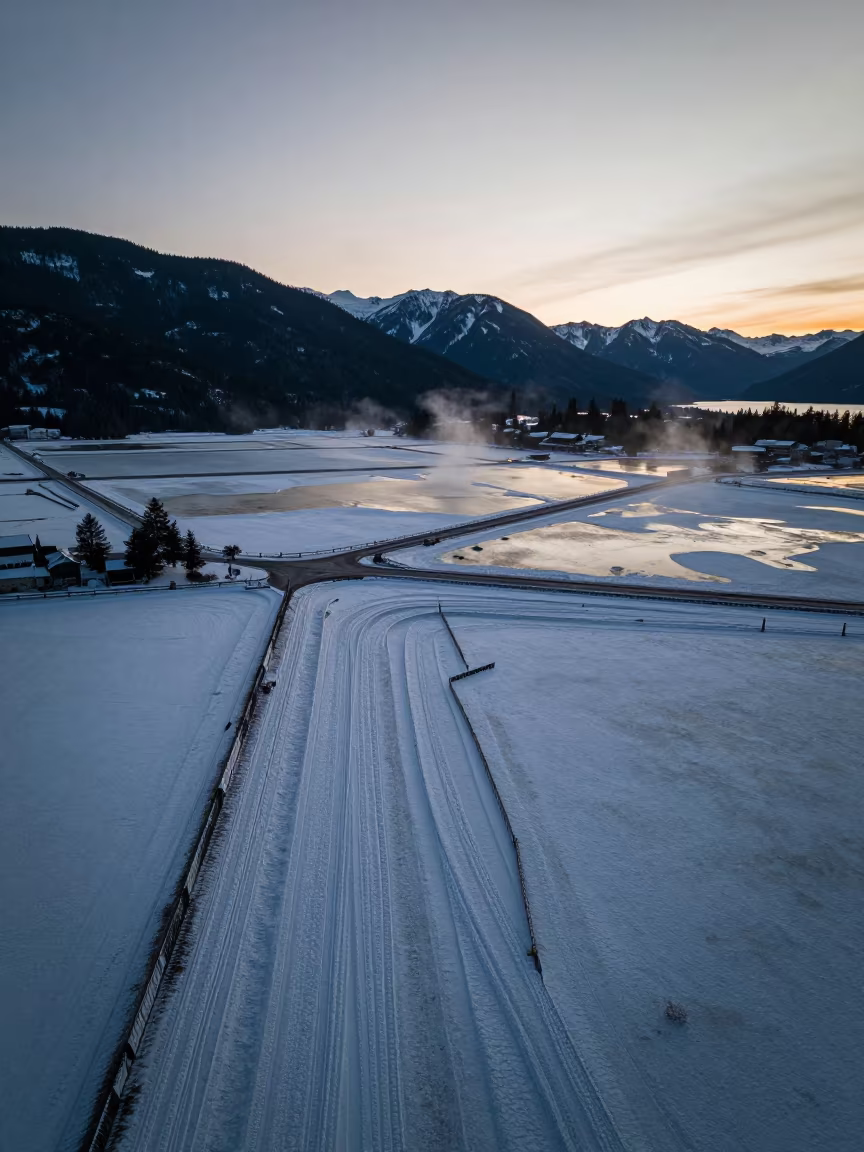 Twilight Snow Fences Drifting Salt Ponds Aerial View in high over salt ponds and causeways in British Columbia