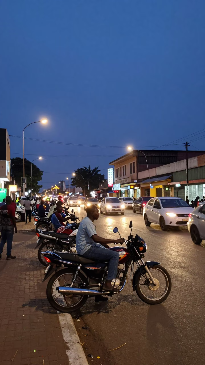 Twilight Street Scene in Accra Ghana with Motorcycle and Urban Life in in Accra, Ghana