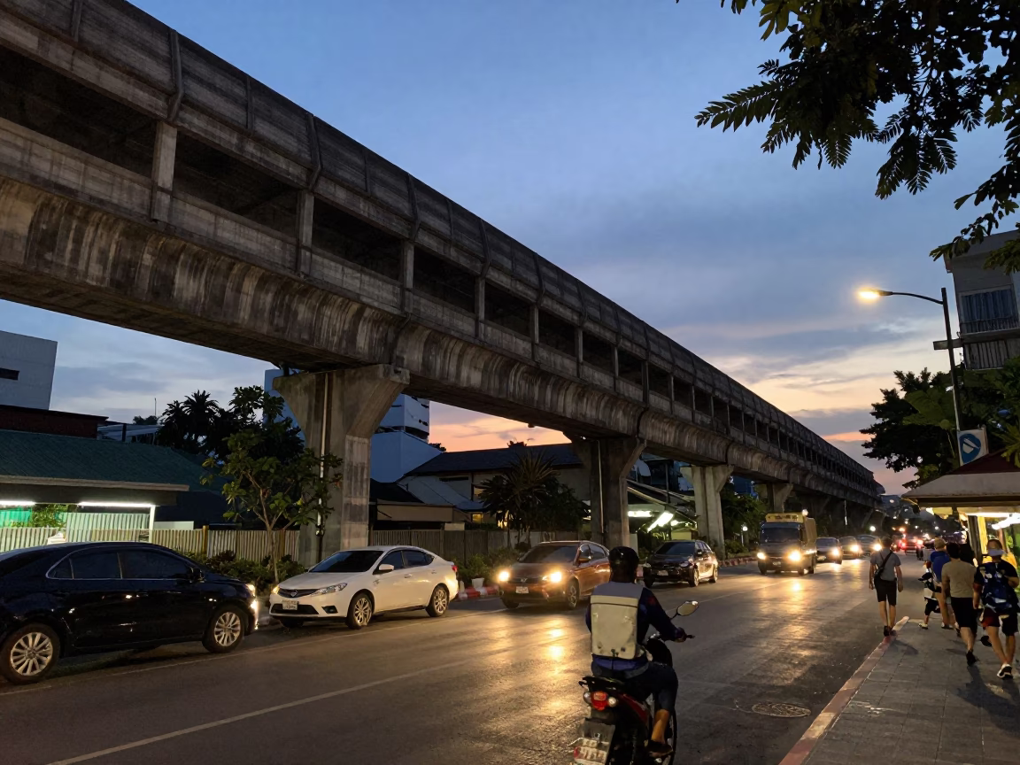 Twilight street scene in Bangkok Thailand with railway viaduct and urban life in in Bangkok, Thailand