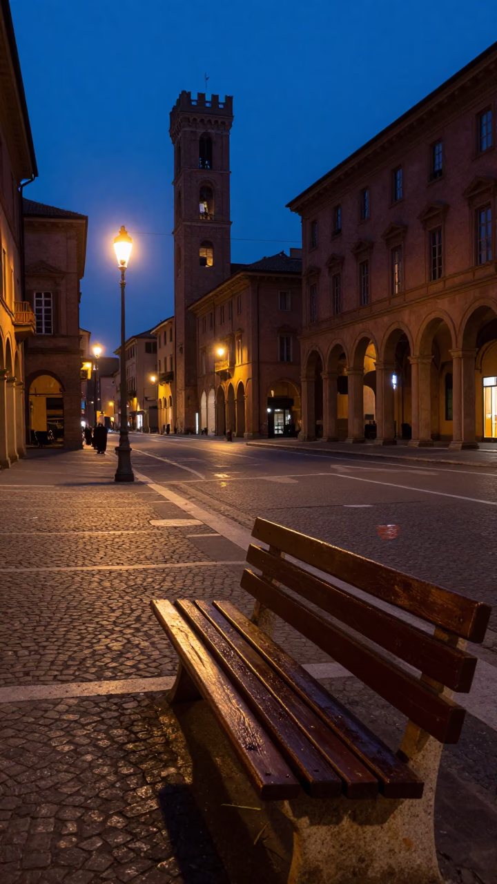 Twilight street scene in Bologna Italy with book light and grease sheen on bench in in Bologna, Italy