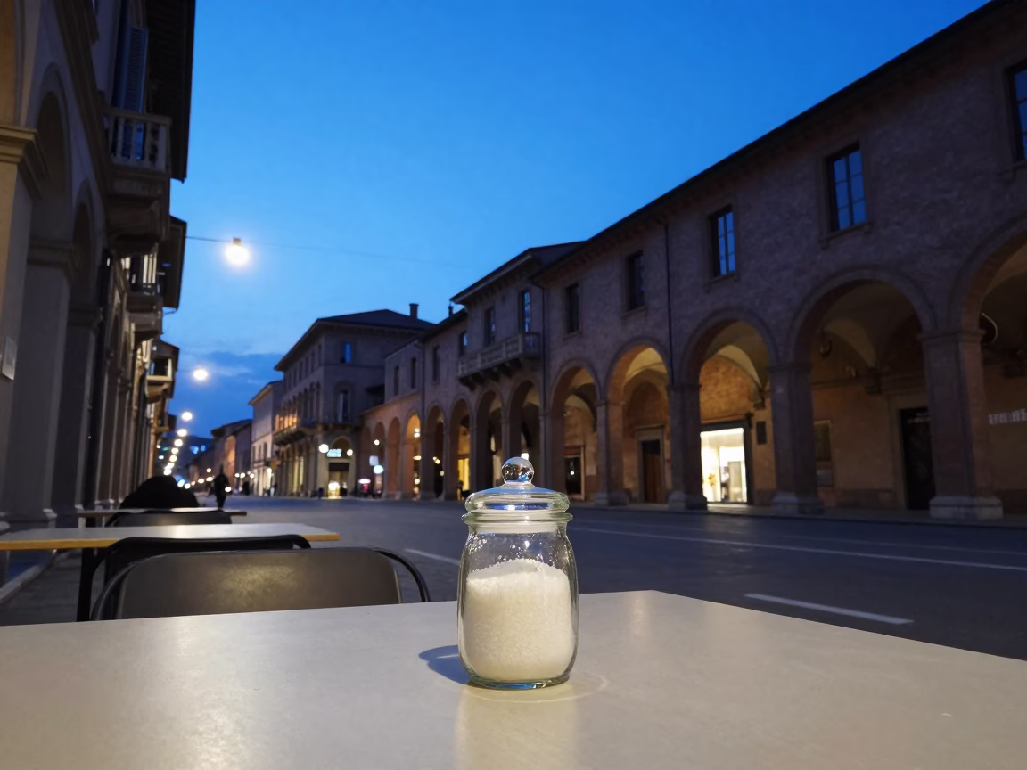 Twilight Street Scene in Bologna Italy with Glass Sugar Jar on Cafe Table in in Bologna, Italy