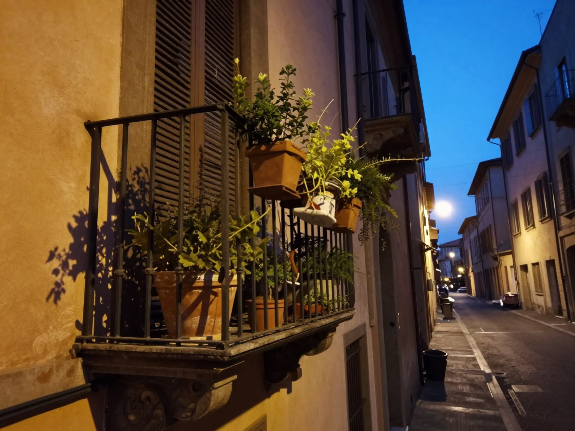 Twilight Street Scene in Bologna Italy with Potted Herbs and Ceramic Plate on Balcony in in Bologna, Italy