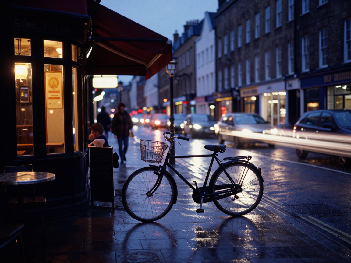 Twilight street scene in Bristol UK with bicycle leaning against cafe and valet stand in in Bristol, United Kingdom