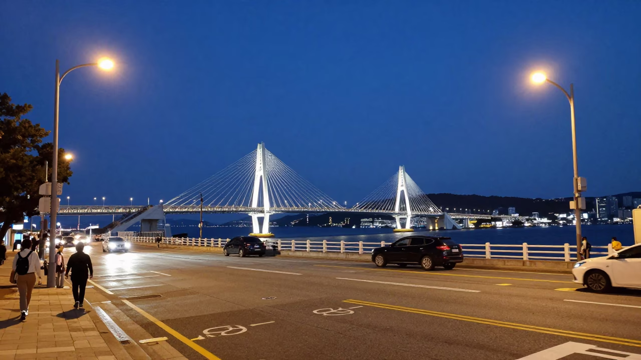 Twilight street scene in Busan South Korea with illuminated cable-stayed bridge and harbor in in Busan, South Korea
