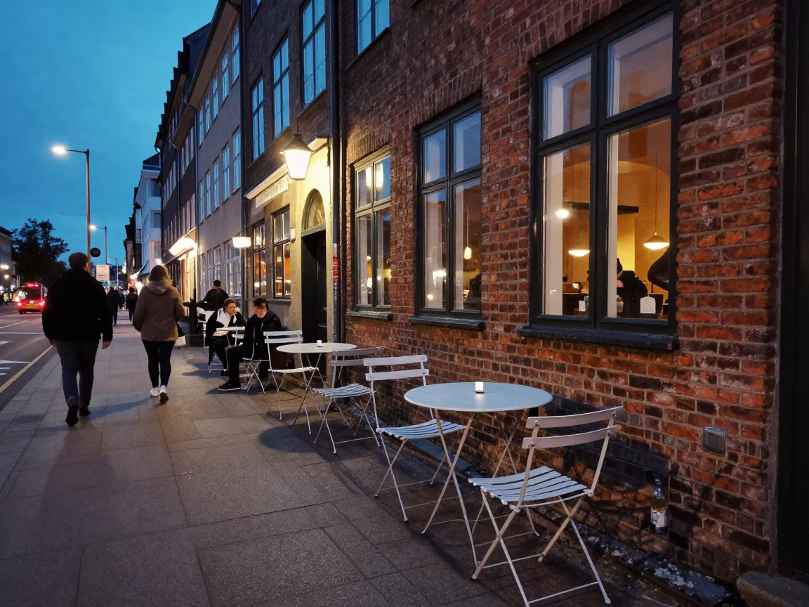Twilight Street Scene in Copenhagen Denmark with Folding Tables and Chairs Outside Cafe in in Copenhagen, Denmark