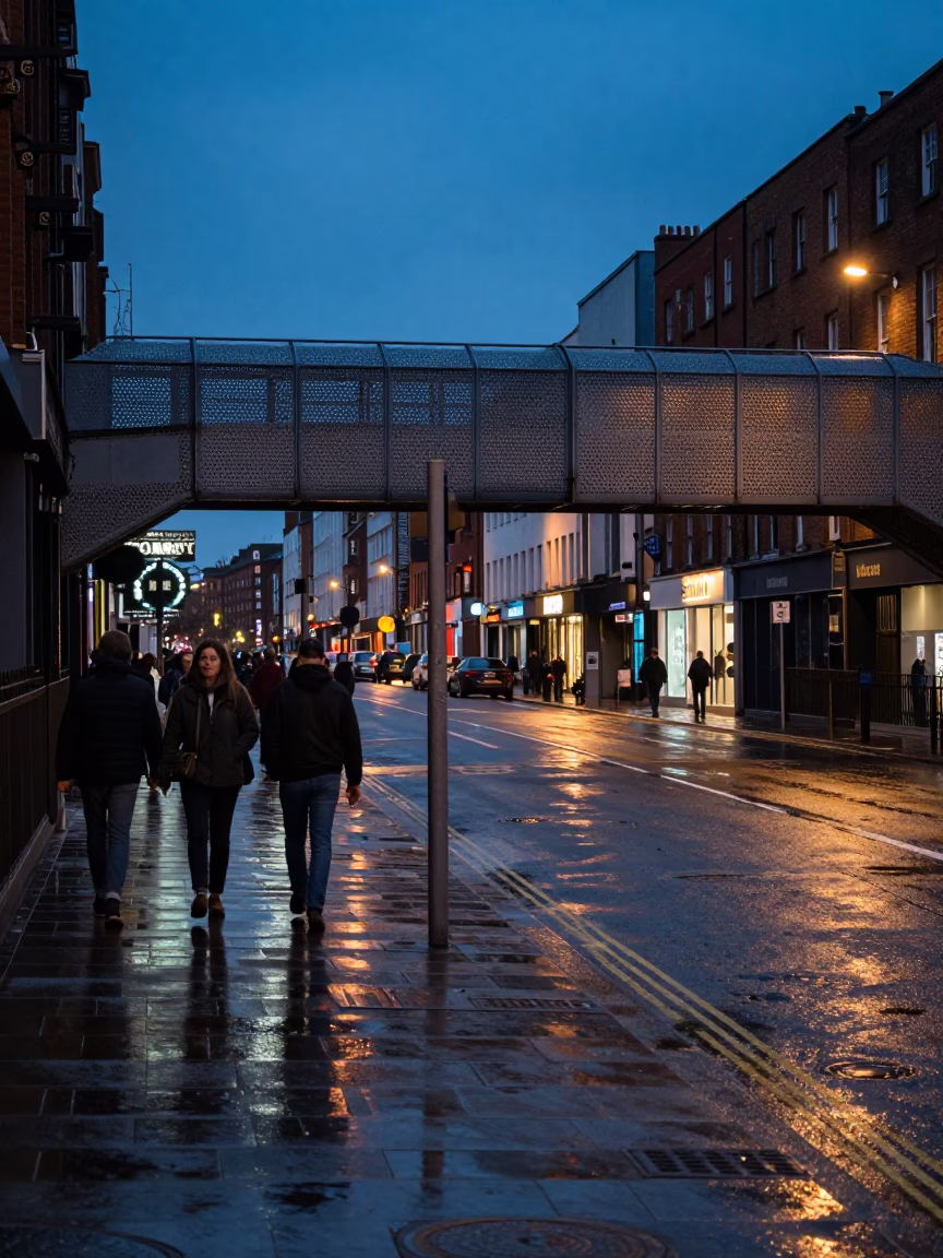Twilight street scene in Dublin Ireland with wet pavement and pedestrian overpass in in Dublin, Ireland