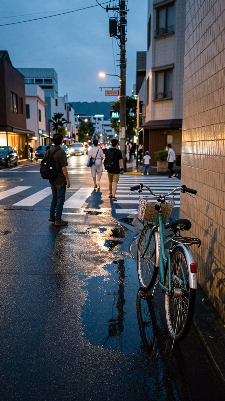 Twilight street scene in Fukuoka Japan with bicycle and puddle reflections of hotel windows in in Fukuoka, Japan