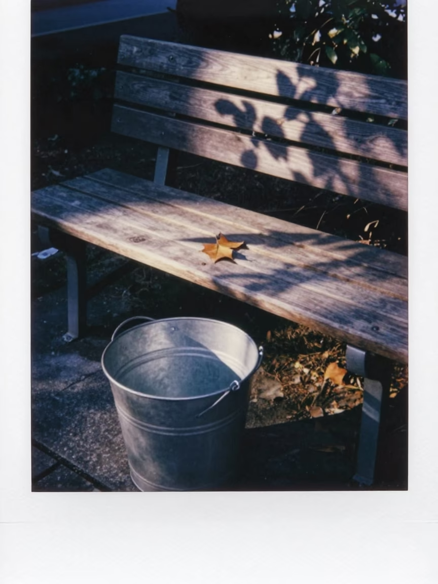 Twilight street scene in Fukuoka Japan with metal bucket and leaf shadows on bench in in Fukuoka, Japan