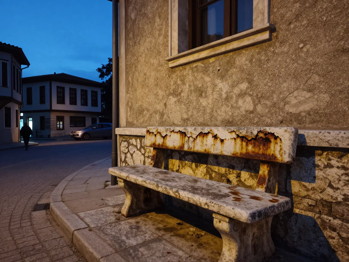 Twilight street scene in Izmir Turkey with stone bench and rusted basin in in Izmir, Turkey