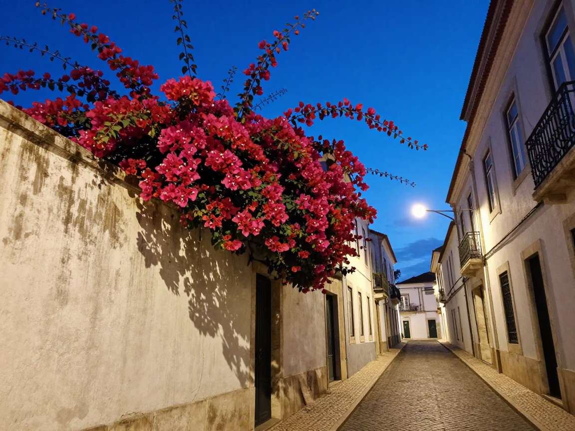 Twilight street scene in Lisbon Portugal with bougainvillea and historic architecture in in Lisbon, Portugal