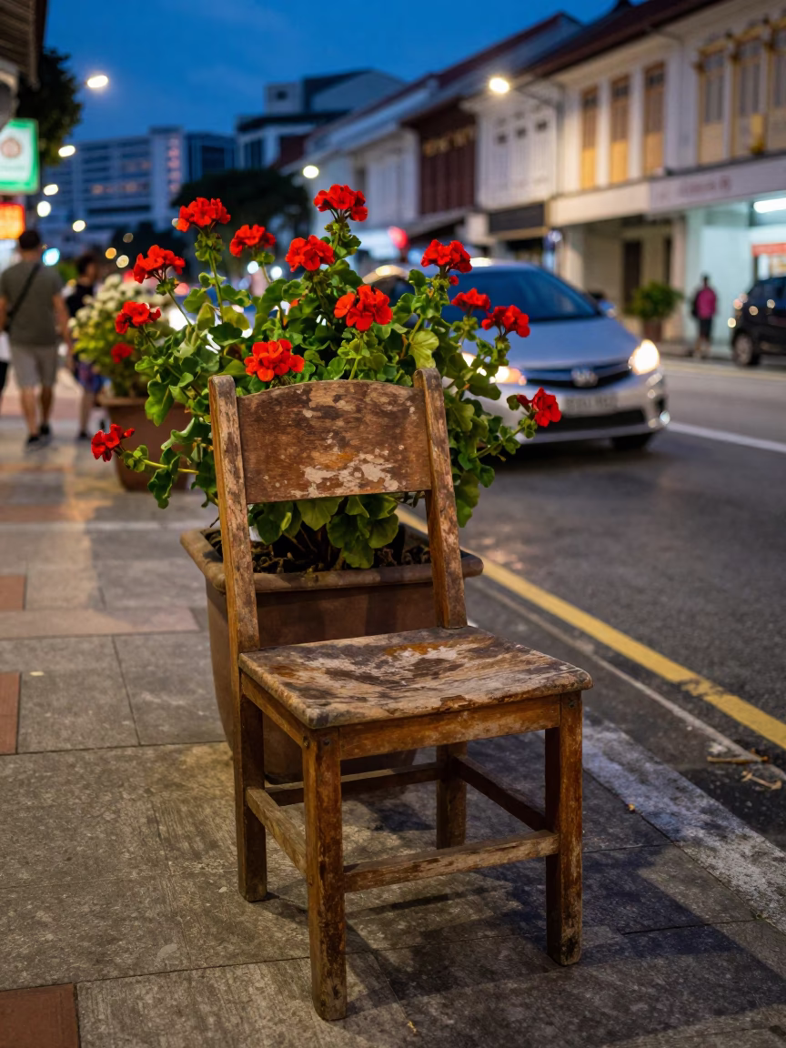 Twilight Street Scene in Singapore with Worn Wooden Chair and Geraniums in in Singapore, Singapore