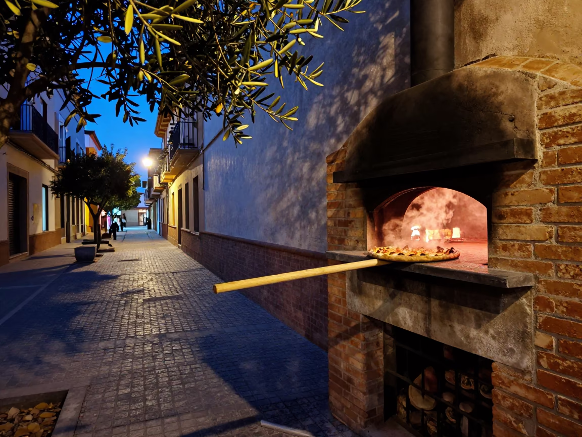Twilight Street Scene in Valencia Spain with Olive Branch and Brick Oven Pizza in in Valencia, Spain