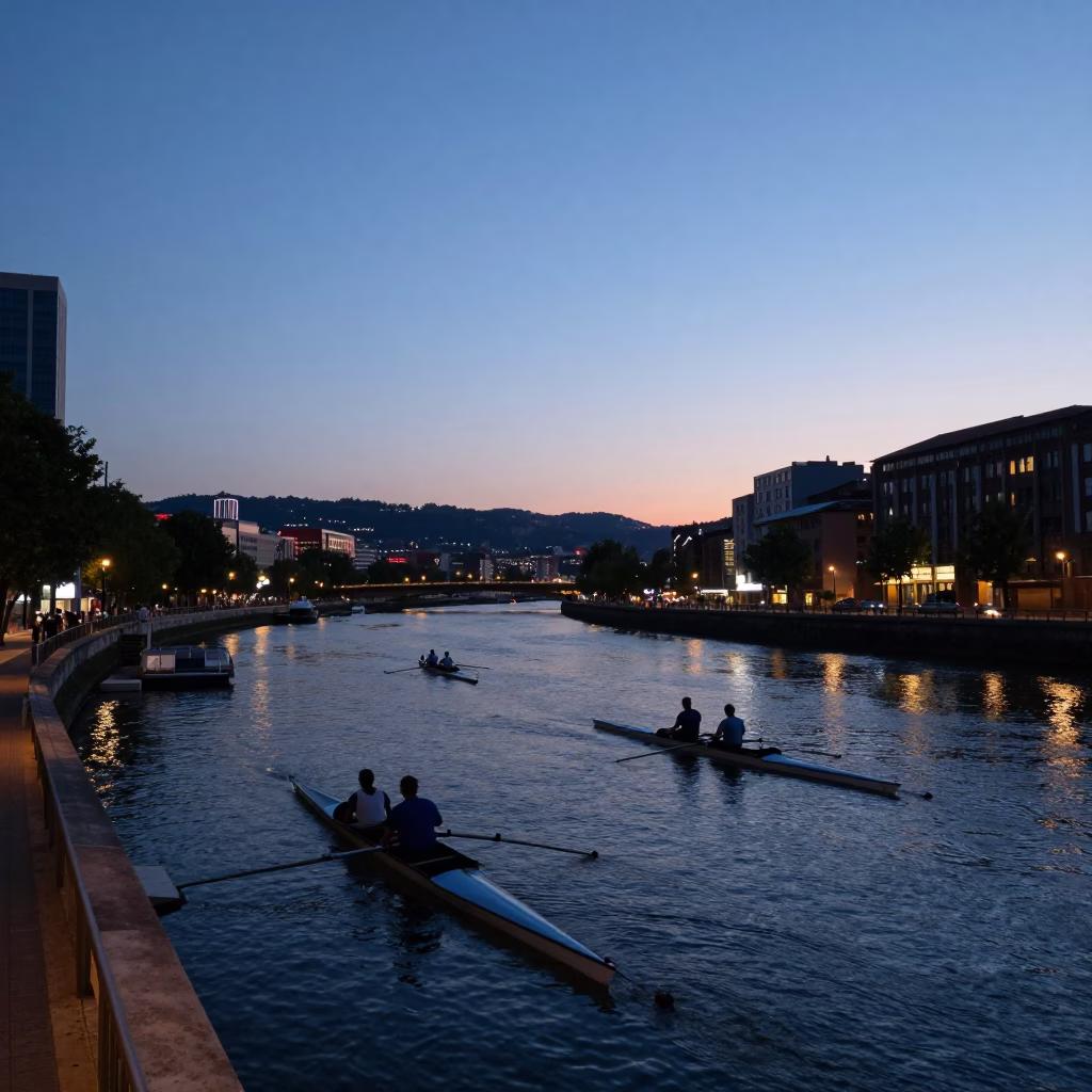 Twilight View of Bilbao's Nervión River with Rowing Boats and City Lights in in Bilbao, Spain