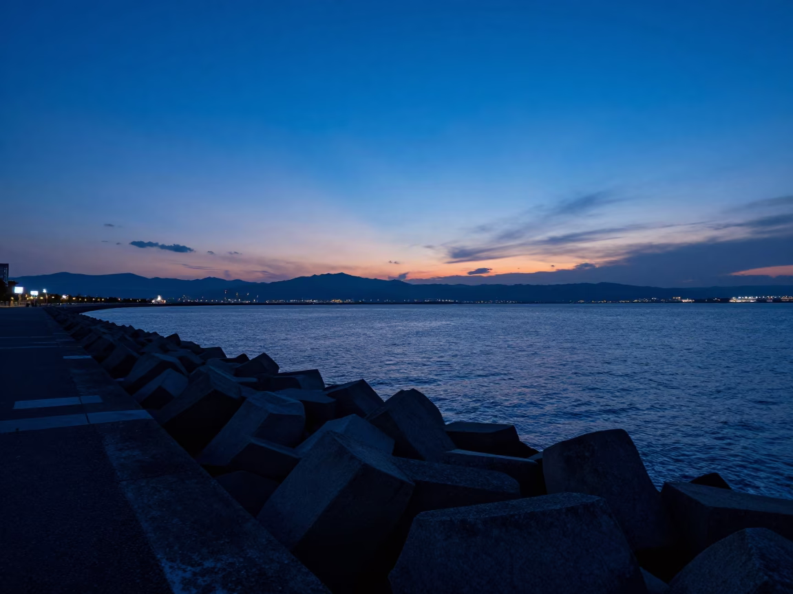Twilight View of Fukuoka Harbor Breakwater with Blue Hour Sky and City Lights in in Fukuoka, Japan