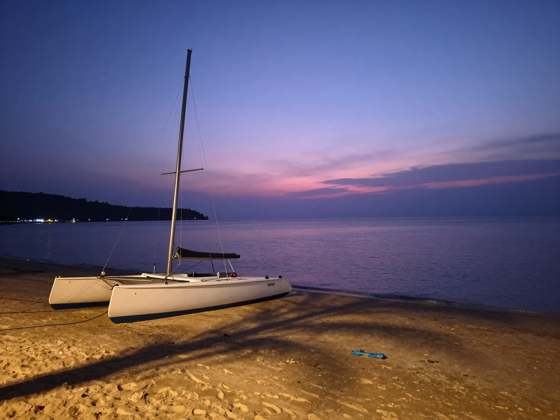 Twilight View of Phuket Thailand Coastline with Beached Catamaran and Tropical Sky in in Phuket, Thailand