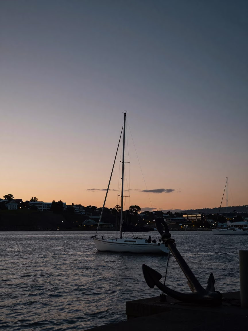 Twilight View of Wellington Harbor with Sailboat Anchor and City Lights in in Wellington, New Zealand
