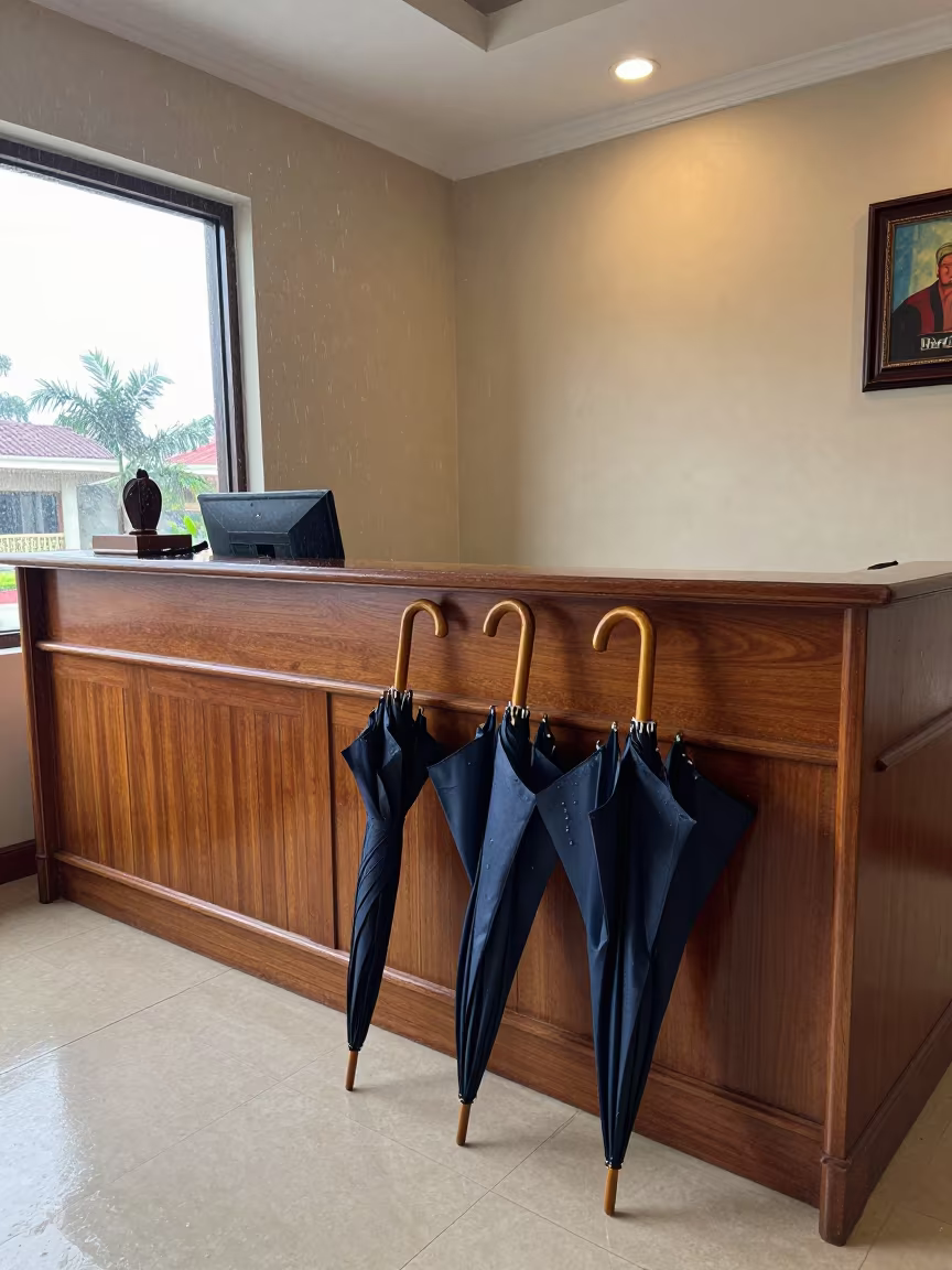 Umbrellas Drying at Dar es Salaam Hotel Desk in at a reception desk under warm light in Dar es Salaam