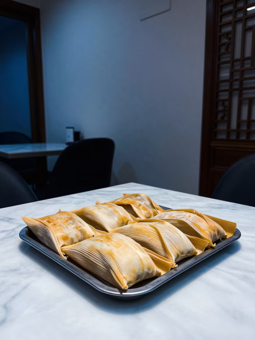 Unwrapped Tamales on Marble Table Mashhad in on a marble cafe table in Mashhad