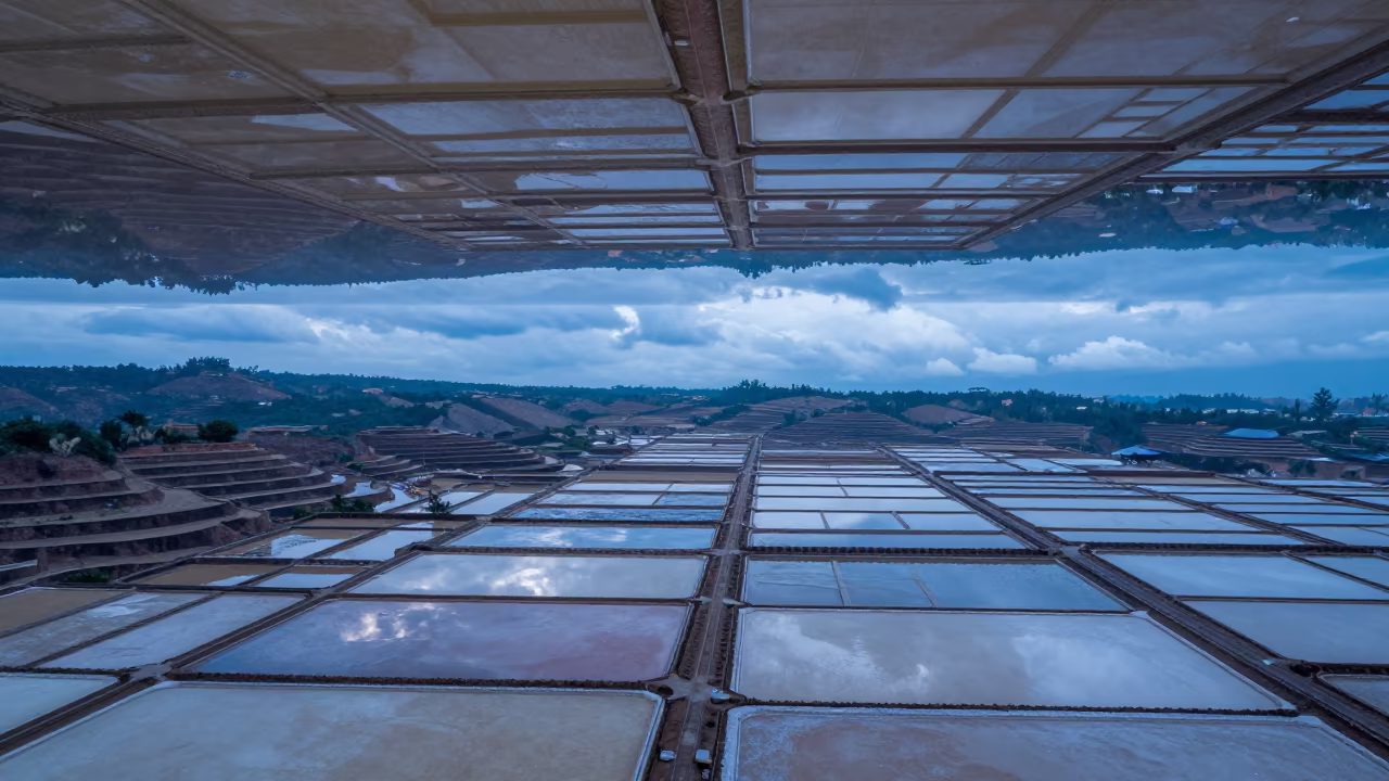 Upside Down Salt Pans Reflected in Water Ceiling in far above terraced hillsides in Indonesia