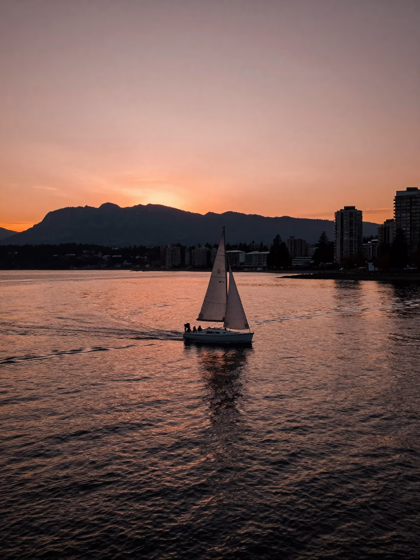 Vancouver BC Downtown Waterfront at Dusk with Sailboat and City Skyline in in Vancouver, British Columbia, Canada