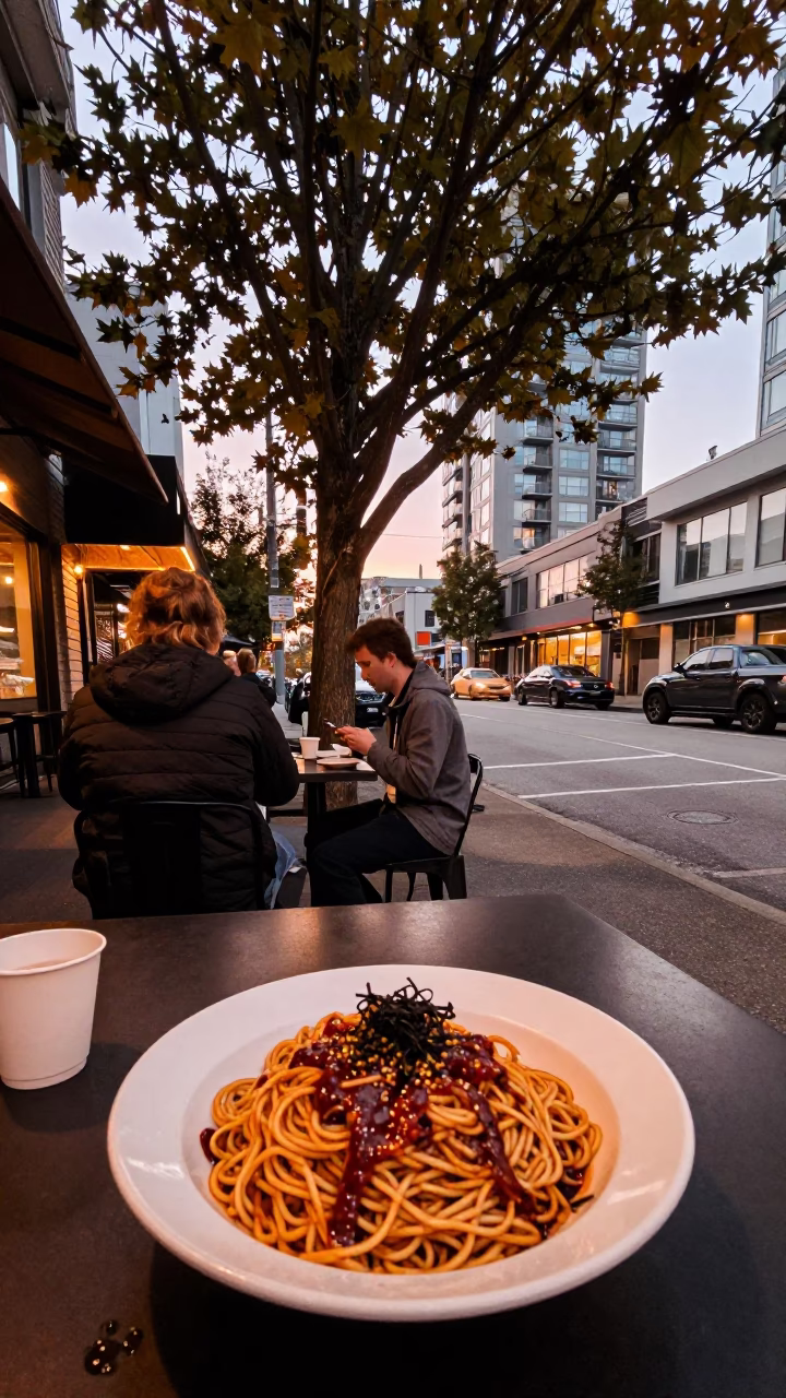 Vancouver Street Scene with Fig Tree and Spicy Noodle Plate in Copper Dusk Light in in Vancouver, British Columbia, Canada