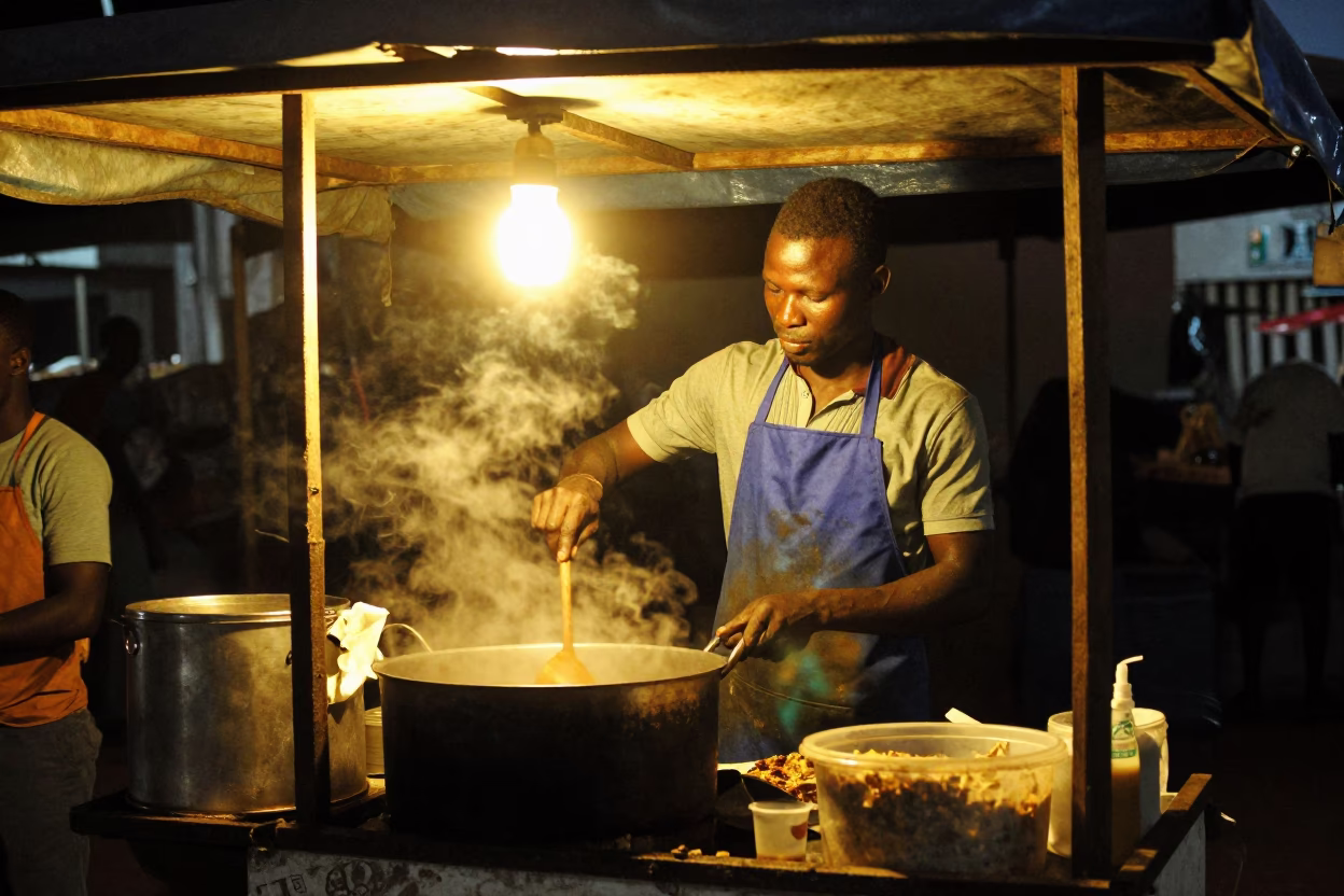 Vendor Cooking in Accra at Deep In The Night Light in in Accra, Ghana