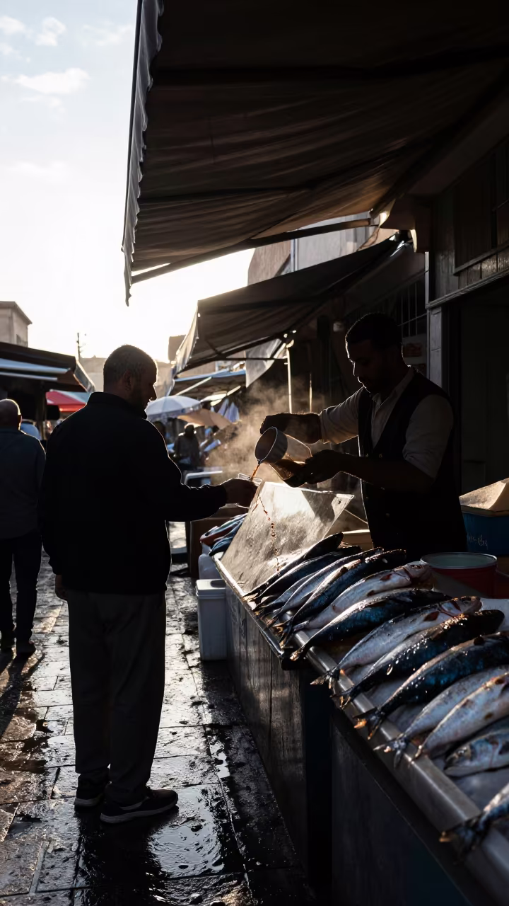 Silhouette Vendor Pouring Coffee at Market in beside a fish counter in Antalya