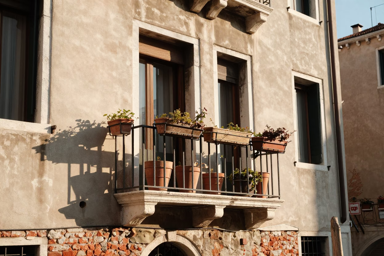 Venetian Morning Light Illuminates Balcony With Terracotta Pots And Canal View in in Venice, Italy