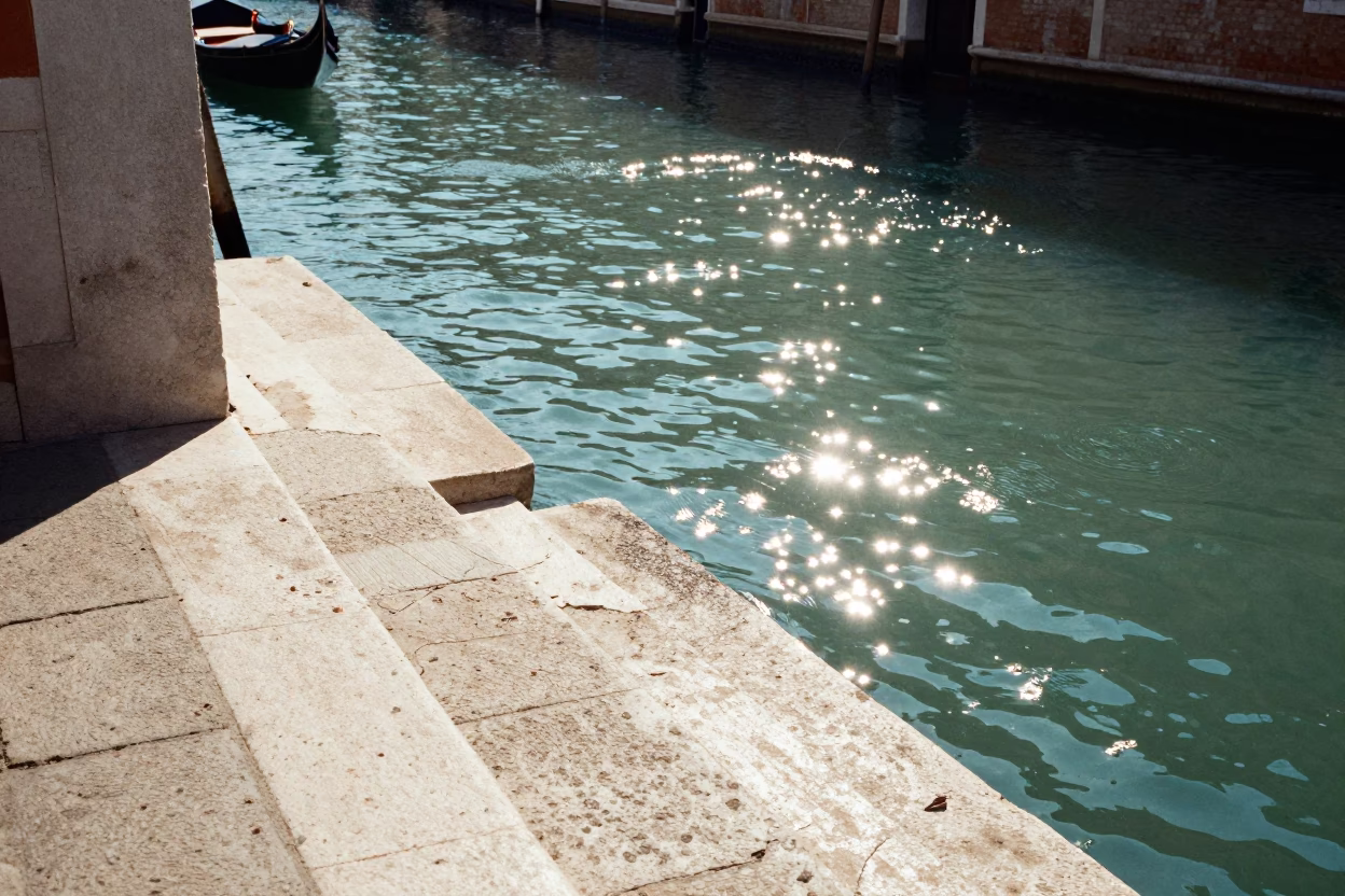 Venetian Noon Sunlight Glaring on Historic Canal Stone Steps and Waterway in in Venice, Italy
