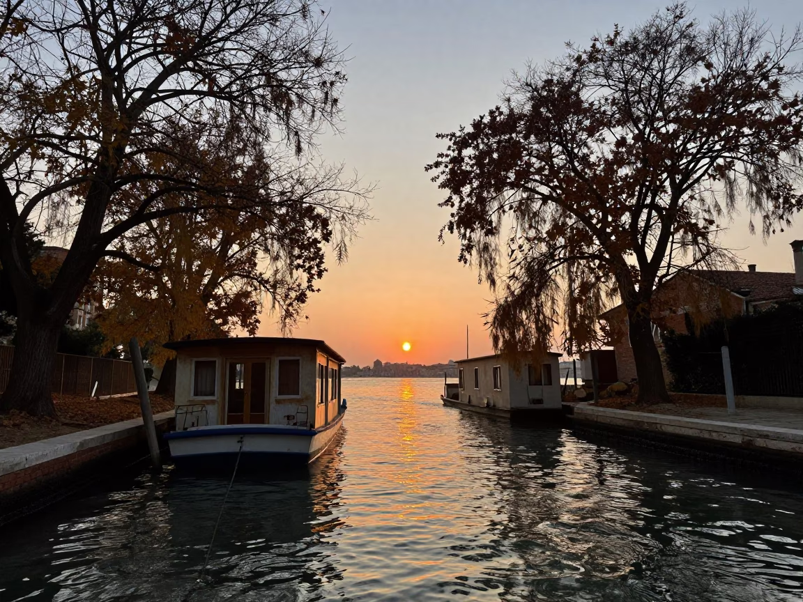 Venice Canal at Dusk with Houseboat and Autumn Willows Reflecting in Water in in Venice, Italy