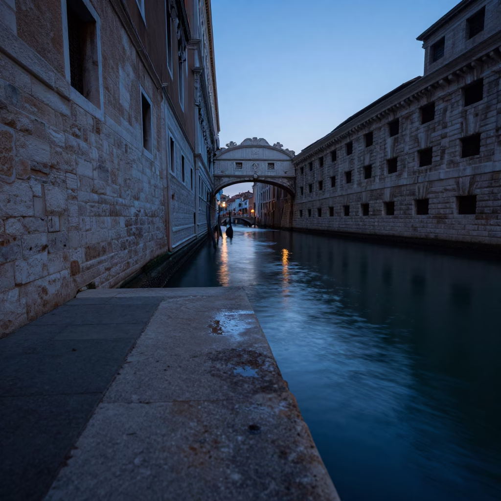 Venice canal edge at blue hour with stone wall and water reflections in in Venice, Italy