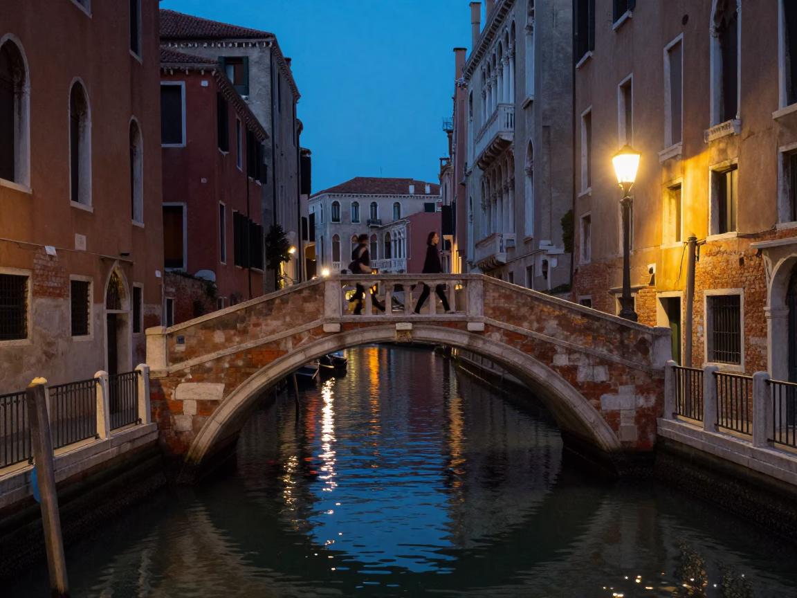 Venice Italy City Lights Glow Narrow Canal Bridge Evening Street Scene in in Venice, Italy