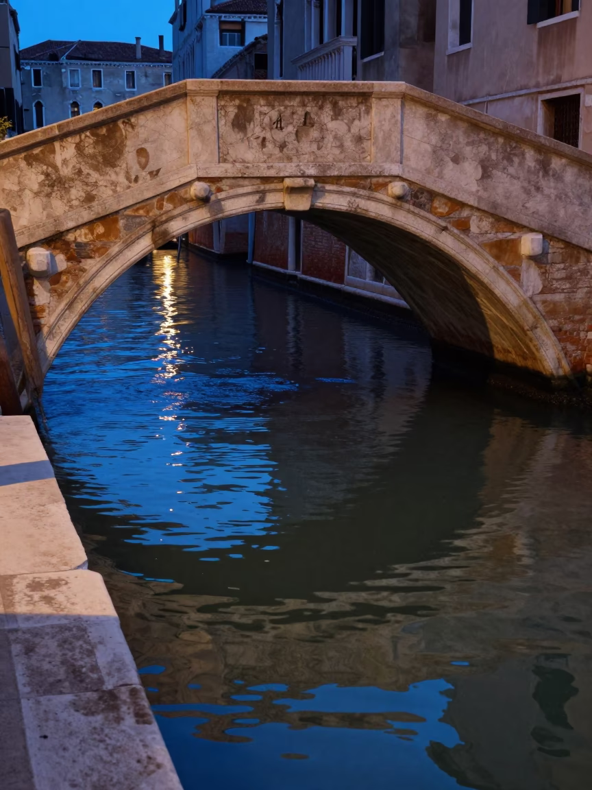 Venice Italy indigo twilight canal scene with bridge pier and traditional gondola in in Venice, Italy