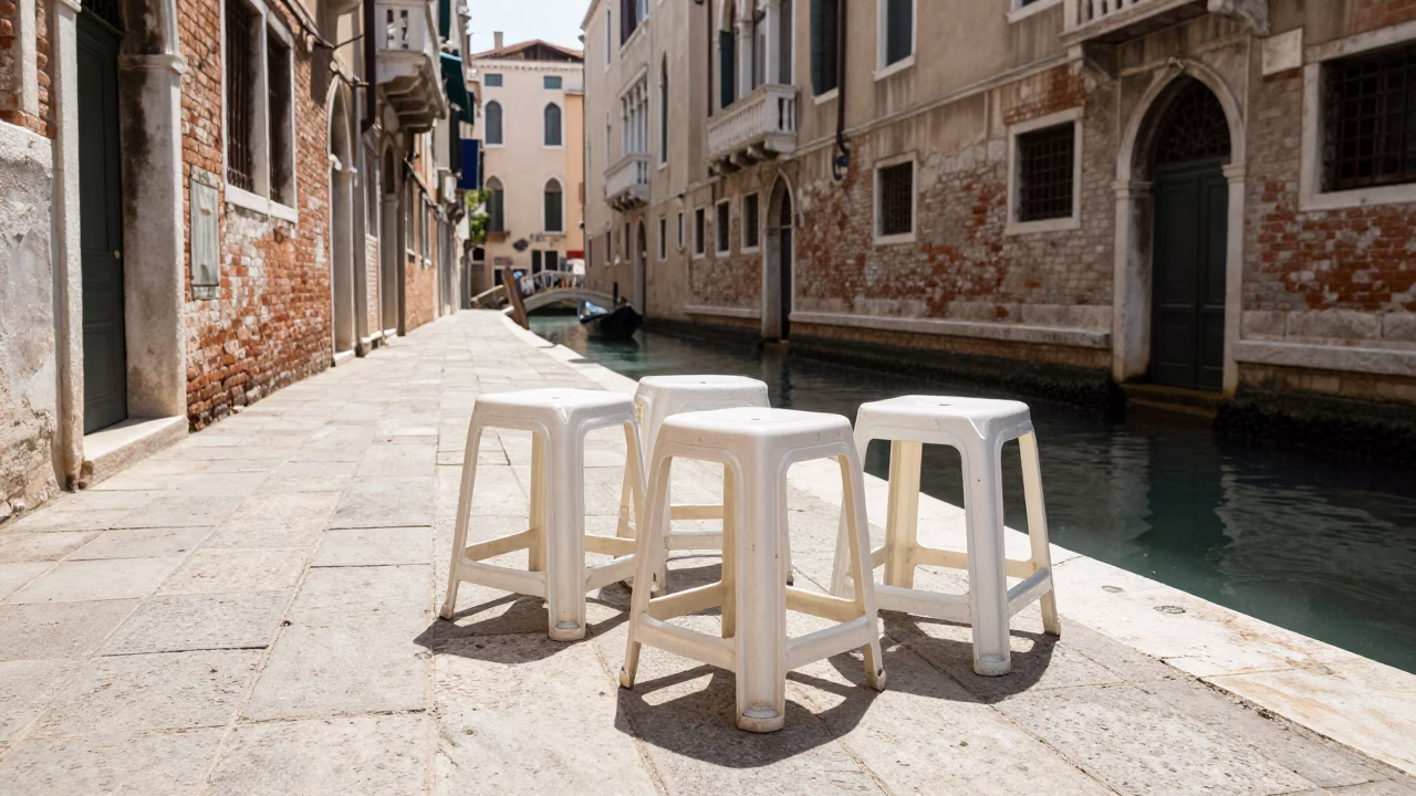Venice Italy Midday Street Scene with Folded Stools and Canal Reflections in in Venice, Italy