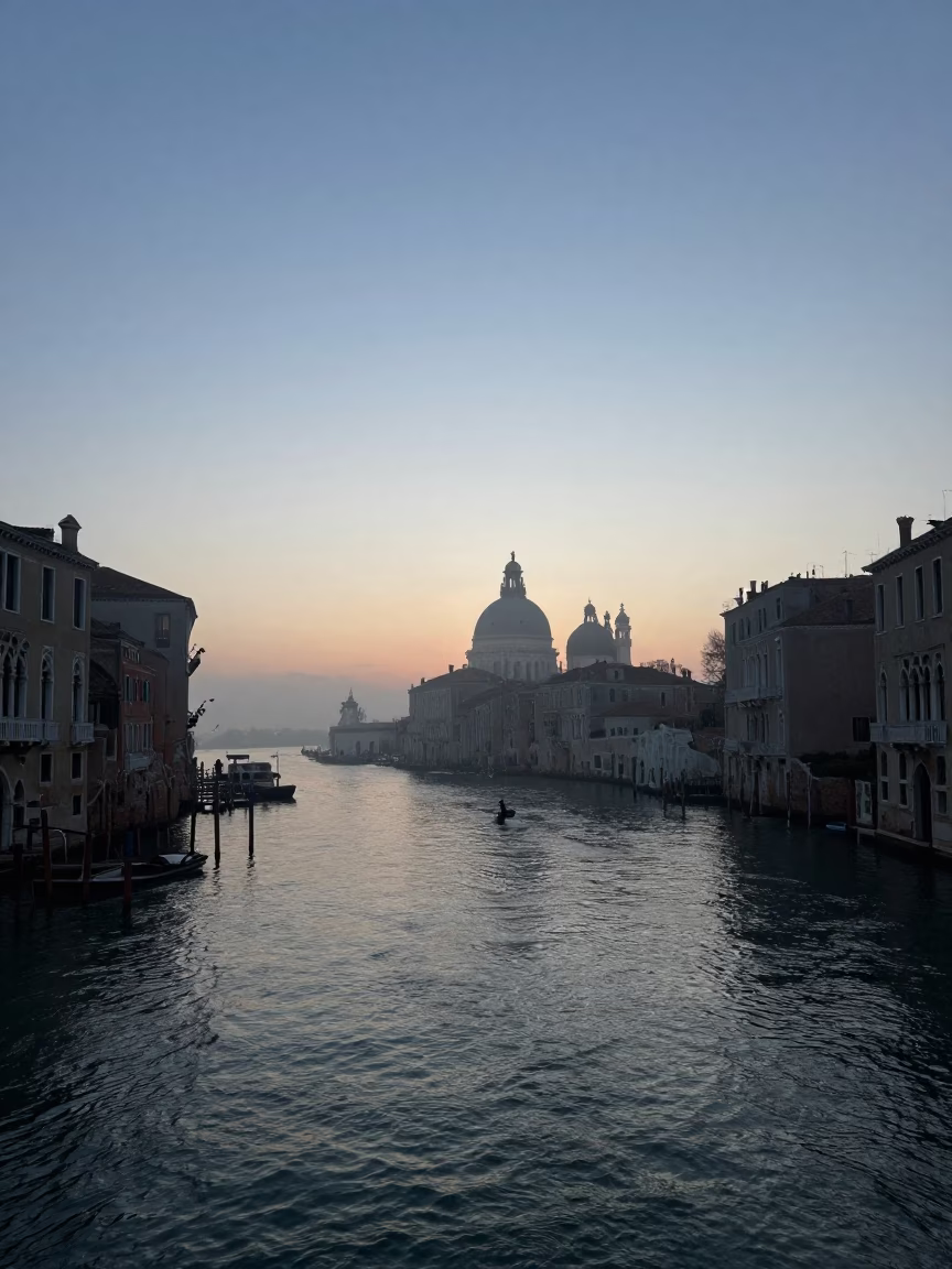 Venice Italy pre-dawn canal view with boatman and foggy atmosphere in in Venice, Italy