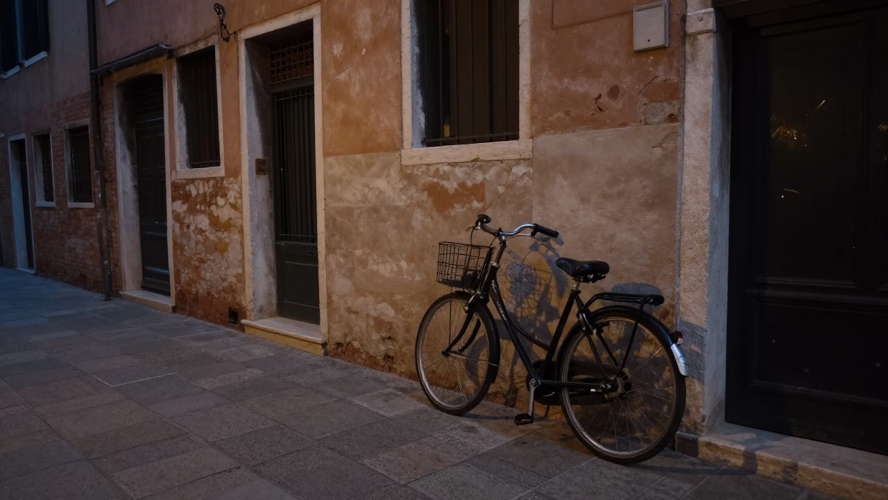 Venice Italy Predawn Street Scene with Leaning Bicycle and Quiet Canal Reflections in in Venice, Italy