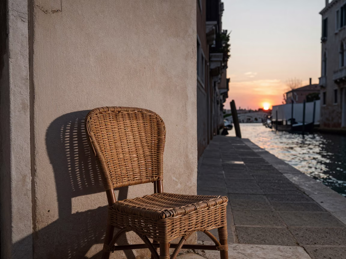 Venice Italy Sunset Canal View with Wicker Chair Shadow on Plaster Wall in in Venice, Italy