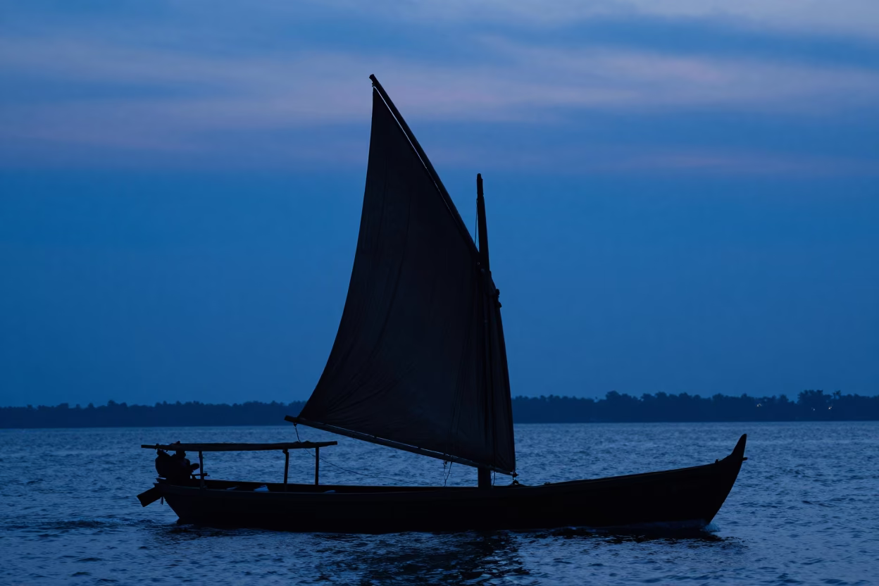 Vibrant Kochi Backwaters Dhow Boat Silhouette Against Indigo Twilight Sky in in Kochi, India