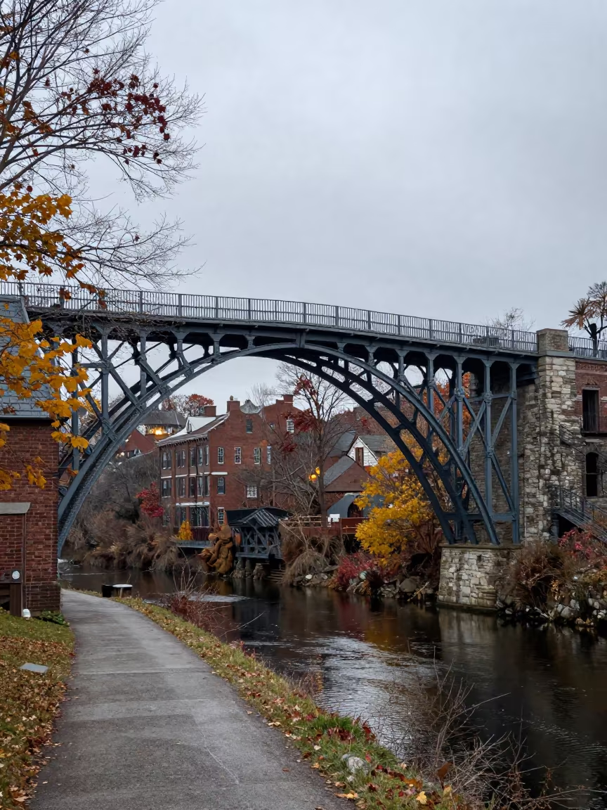 Victorian Iron Bridge Over Gorge at Night in beside a canal-front facade in Connecticut