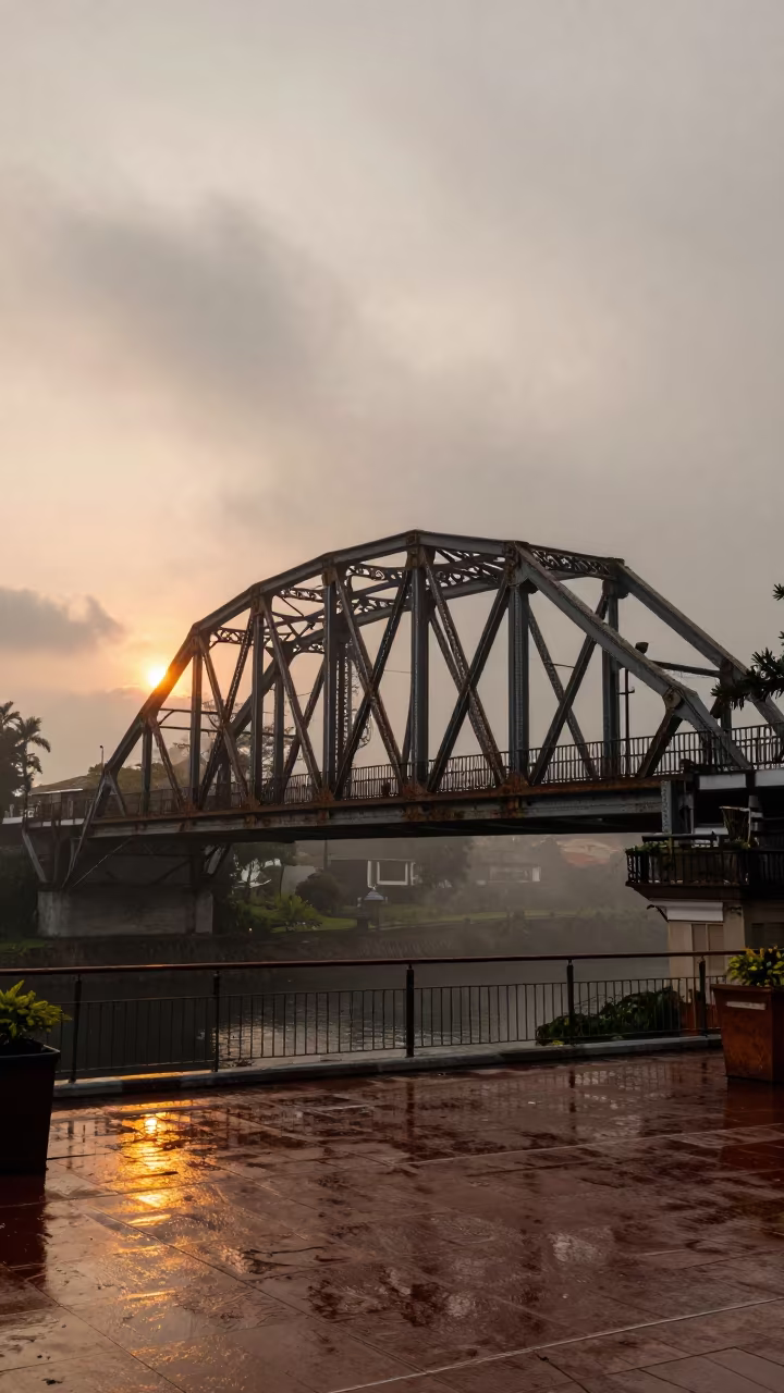 Victorian Iron Bridge Over Misty Gorge at Sunset in across a formal civic plaza near Manila