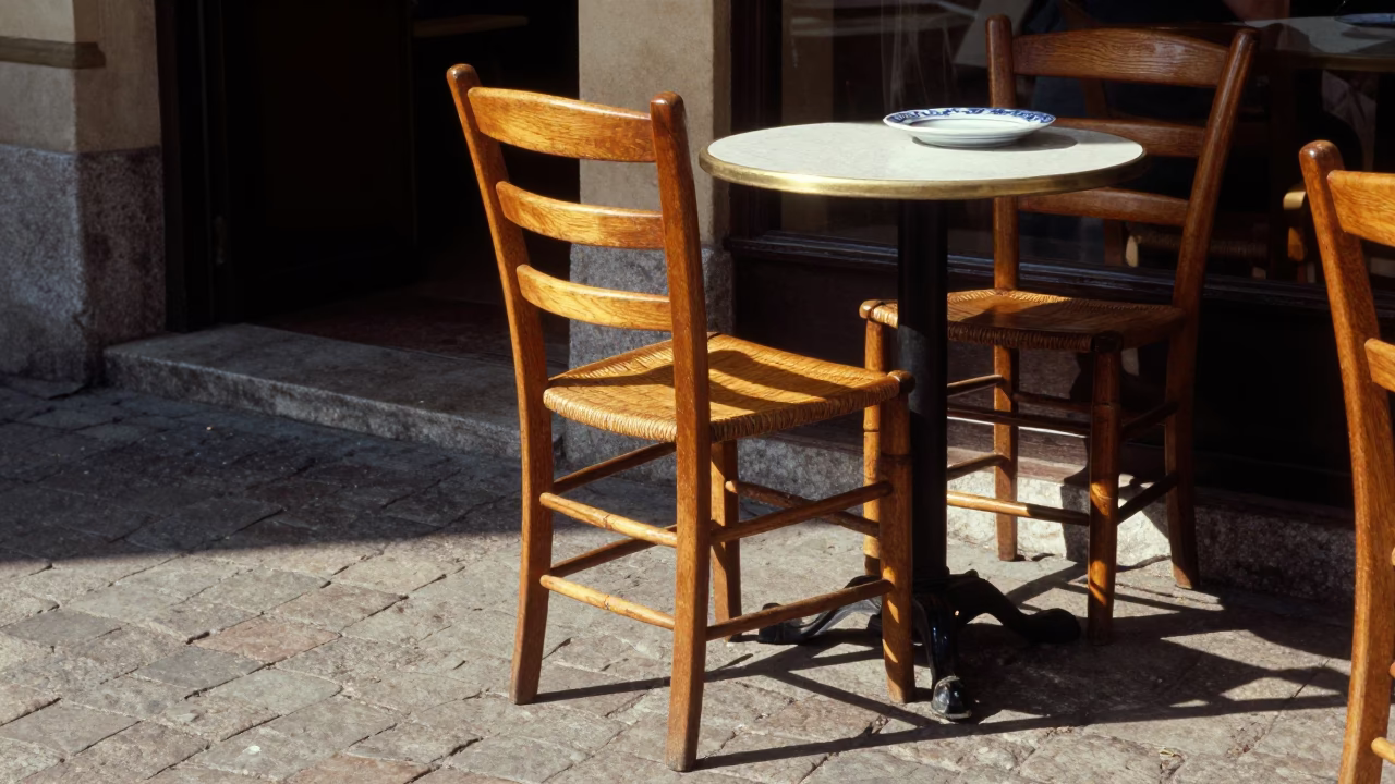 Vienna Café Terrace Ladder-Back Chair and Blue Porcelain Plate in Late Afternoon Sunlight in in Vienna, Austria