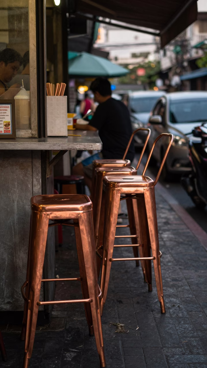 Vintage Bangkok Street Scene Copper Dusk Light Bar Stools and Local Interaction in in Bangkok, Thailand