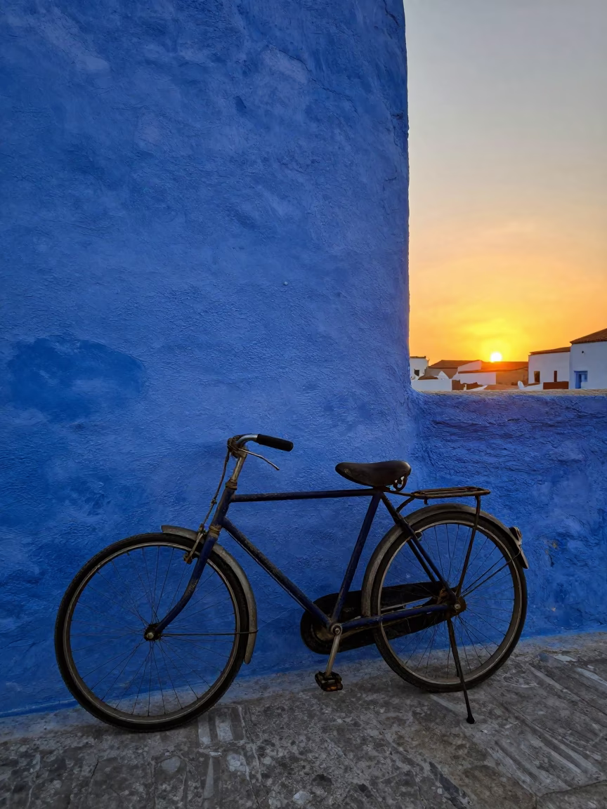 Vintage Bicycle Against Blue Wall in Essaouira Morocco at Sunset in in Essaouira, Morocco