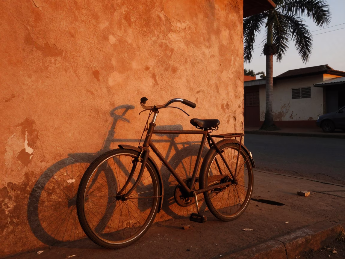 Vintage Bicycle Against Wall in Accra Ghana at Sunset with Palm Silhouette in in Accra, Ghana