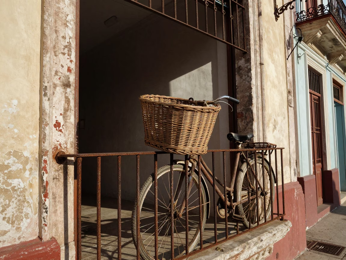 Vintage Bicycle Basket Resting on Colonial Havana Balcony in Late Afternoon Sunlight in in Havana, Cuba