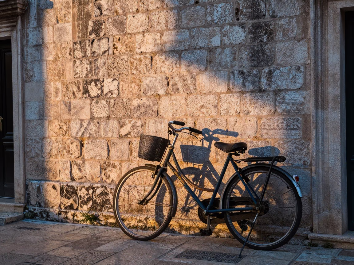 Vintage Bicycle Leaning Against Ancient Stone Wall in Dubrovnik at Dawn in in Dubrovnik, Croatia