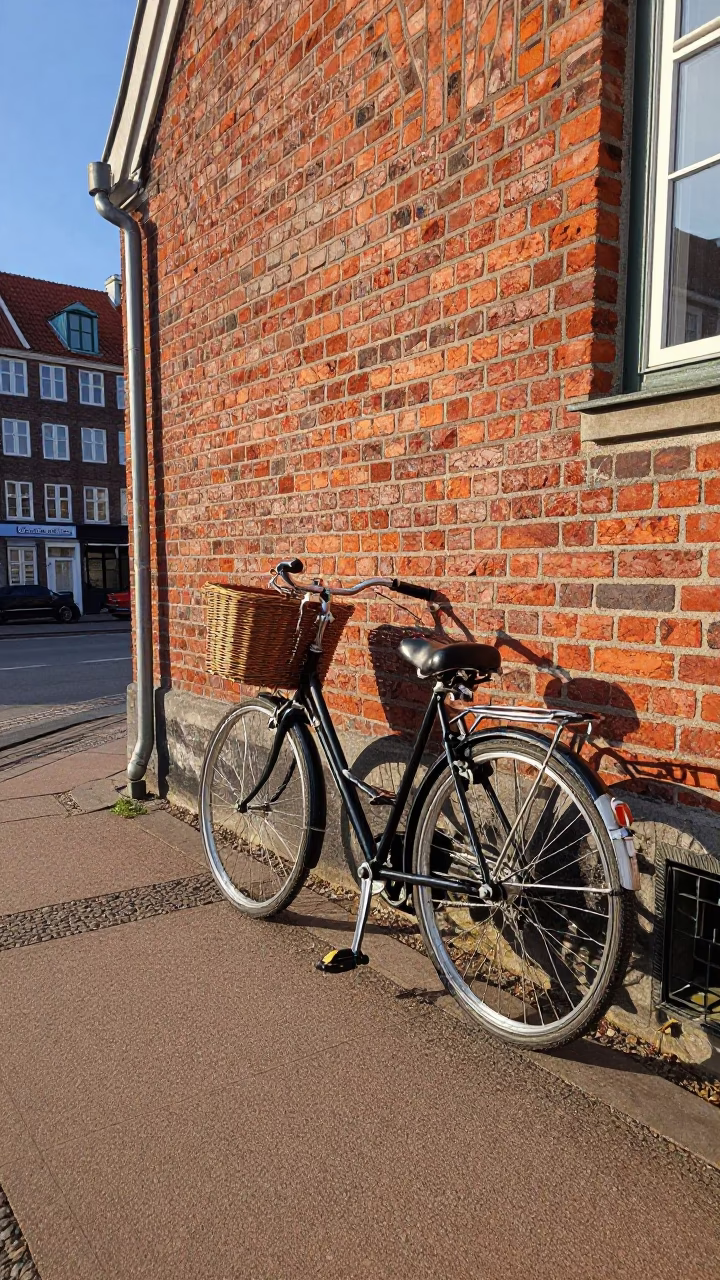 Vintage Bicycle Leaning Against Brick Wall in Copenhagen Denmark Early Afternoon in in Copenhagen, Denmark